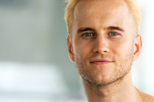 Portrait Caucasian man blue eyes blond hair smiling face headshot in studio. Handsome White people men look at camera standing in casual clothing. Portrait Happy Confidence cheerful businessman