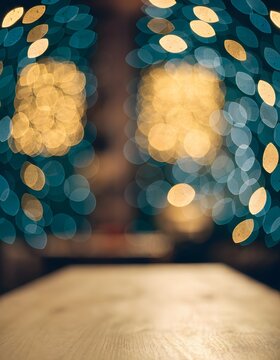 Empty wooden table with festive bokeh background for Christmas.