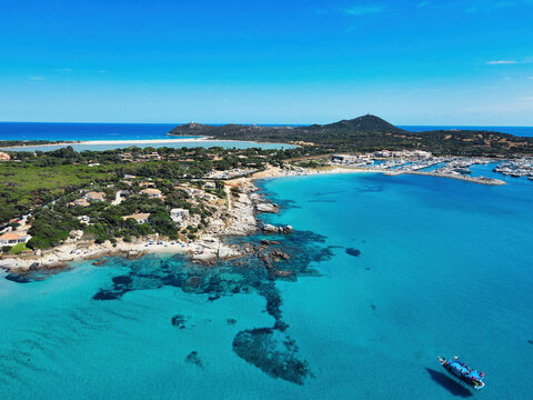 Aerial view of the rocky coast of Campulongu with turquoise sea, marina and Capo Carbonara promontory, Villasimius, Sardinia, Italy