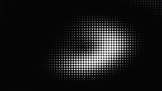 Monochrome halftone dot pattern moving in continuous wave animation across a dark background video footage