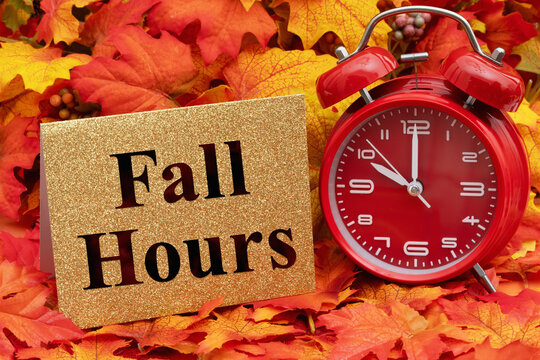 Fall Hours with fall leaves and alarm clock