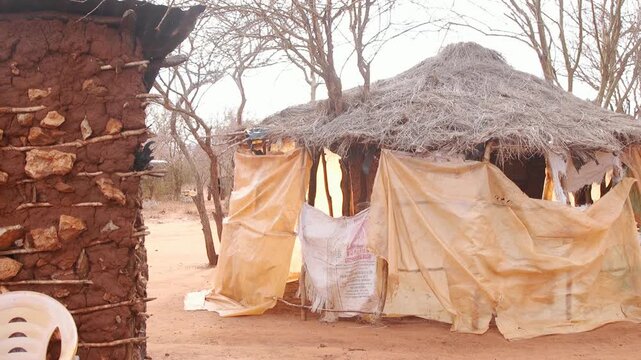 Thatched hut with sack curtains in a rural village