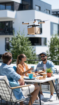 Couple enjoying lunch on terrace as delivery drone hovers nearby, modern urban setting