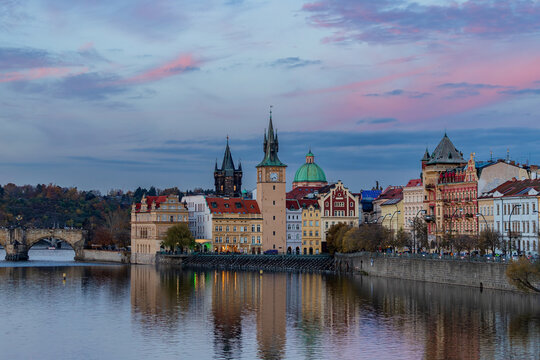 A view of Novotneho lavka - Smetanovo  embankment (Smetanovo nabrezi) with historical buildings and their reflection in Vltava River. Prague, Czech Republic 