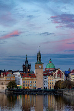  A view of Novotneho lavka - Smetanovo  embankment (Smetanovo nabrezi) with historical buildings and their reflection in Vltava River. Prague, Czech Republic 