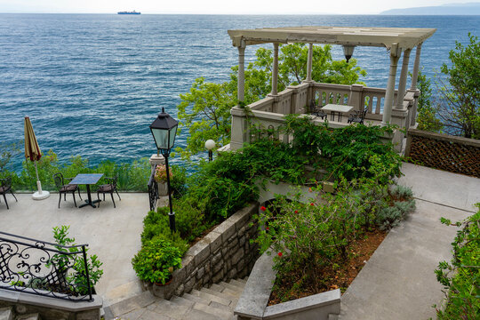 scenic seaside terrace with pergola, chairs, and ocean view, peaceful getaway