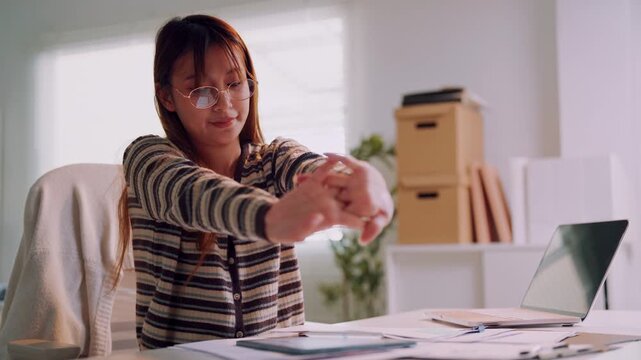 Work fatigue and stress, tired young Asian woman taking a break at office desk