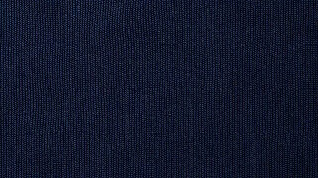 Dark blue woven fabric texture fills the frame as a tactile textile surface. Textile design, fashion advertising, and apparel presentation.