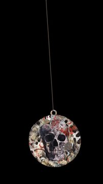 An animated Halloween themed hanging element in a paper-collage style that gently sways on a loop and features spooky ephemera details.
