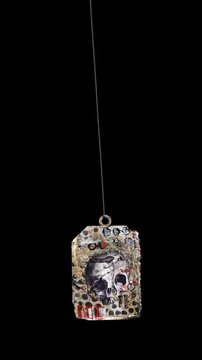 An animated Halloween themed hanging element in a paper-collage style that gently sways on a loop and features spooky ephemera details.
