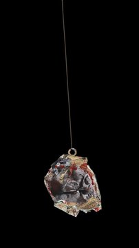 An animated Halloween themed hanging element in a paper-collage style that gently sways on a loop and features spooky ephemera details.
