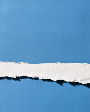 Torn White Paper Strip on Blue Textured Background
