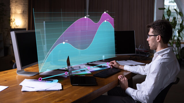 Seated analyst monitoring rising area charts across floating dashboard at office workstation. Financial forecasting, business reporting and decision support concept.