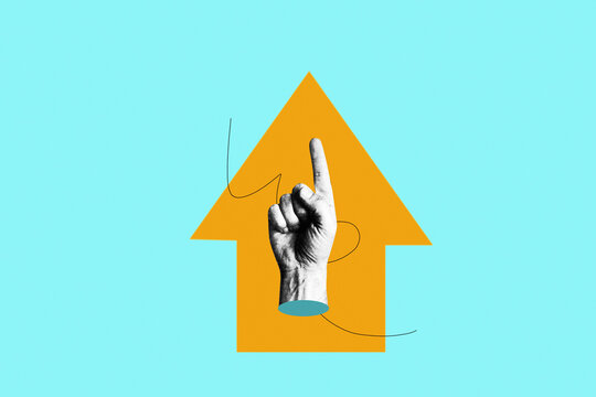 Human hand pointing index finger upward in front of yellow arrow