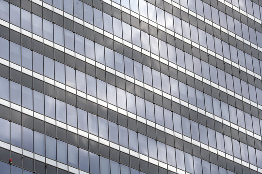 View of the glass facade of the Pipera Business Tower with repeating horizontal window panels and steel frames in Bucuresti, Bucuresti, Romania.