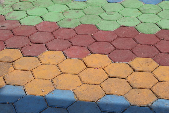 Colorful paving blocks installed on the ground create a durable decorative surface for outdoor pathways, gardens, sidewalks, and landscaping projects.