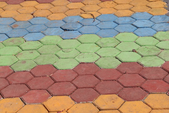 Colorful paving blocks installed on the ground create a durable decorative surface for outdoor pathways, gardens, sidewalks, and landscaping projects.