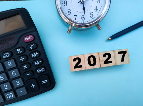 New Year 2027 financial planning, yearly budget management, time management, tax return deadline, business goals and savings strategy concept