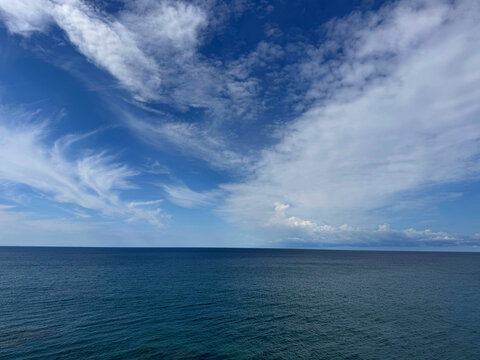 Blue ocean and blue sky with beautiful clouds