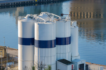 Tall White Silo Storage Cement at Port in Oslo Norway © markobe