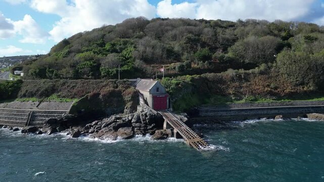 Penlee, Cornwall, England: DRONE VIEWS: The old Penlee lifeboat station. The station was closed down after the 1981 Penlee lifeboat disaster, when sixteen people lost their lives in a failed rescue.