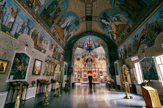 View of the ornate interior of the Holy Resurrection Cathedral with vibrant religious frescoes, golden chandeliers, and icons in Bishkek, Bishkek City, Kyrgyzstan.