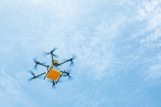 Autonomous delivery drone carries food package through the sky in Shenzhen, China. Autonomous delivery, unmanned logistics, last mile transportation, food delivery automation, smart city technology