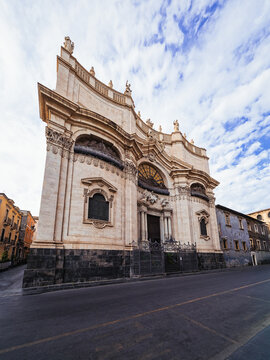 Striking Mediterranean travel photograph capturing the dramatic Baroque corner architecture of Badia di Sant'Agata, ideal for Sicilian travel guidebooks, architectural media, and tourism campaigns.