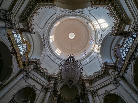 low angle perspective, interior dome geometry, marble column texture, white stucco molding, crystal chandelier detail, dome lantern illumination