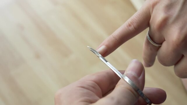Careful Fingernail Trimming with Curved Manicure Scissors