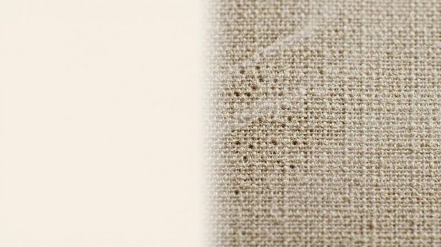 Extreme macro shot of raw linen fabric with subtle microscopic vapor flowing through pores. Static locked-off composition with ample neutral copy space on the left. Ideal for sustainable textiles, 