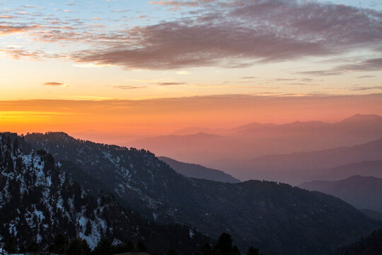 View of the sunset over the snow-covered slopes and forested mountains of Malam Jabba, Swat, Khyber Pakhtunkhwa, Pakistan.