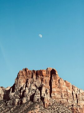 Red rock desert butte with rising moon at Zion National Park