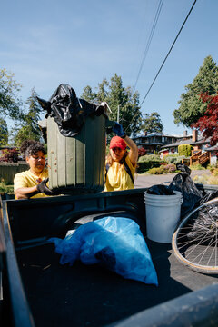 Volunteers loading trash during neighborhood cleanup