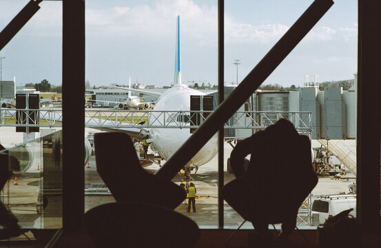Terminal Silhouettes Against a Passenger Jet