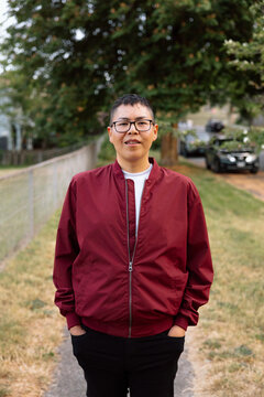 Candid outdoor portrait of a person in a red jacket