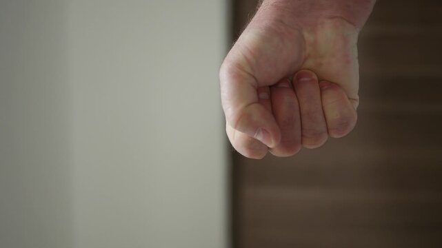 Shooting with an Angry Man Clenching the Fist in Sign of Protest. One Person Getting Mad and Clench the Hand Fingers in a Fist.