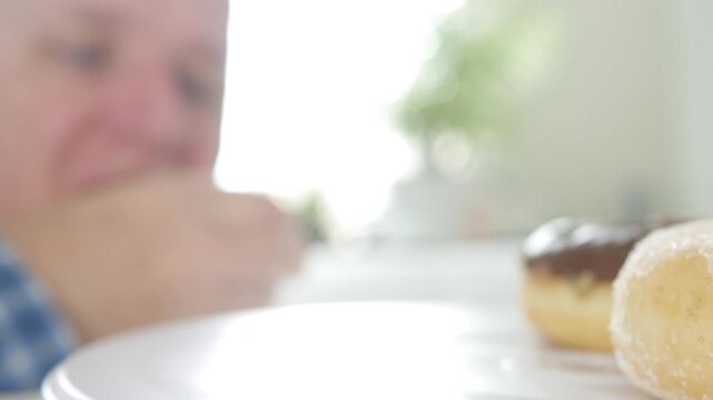 Hungry Person Eating Sweet and Tasty Doughnuts Glazed in Chocolate or Powdered with White Sugar. Traditional Homemade Donuts.