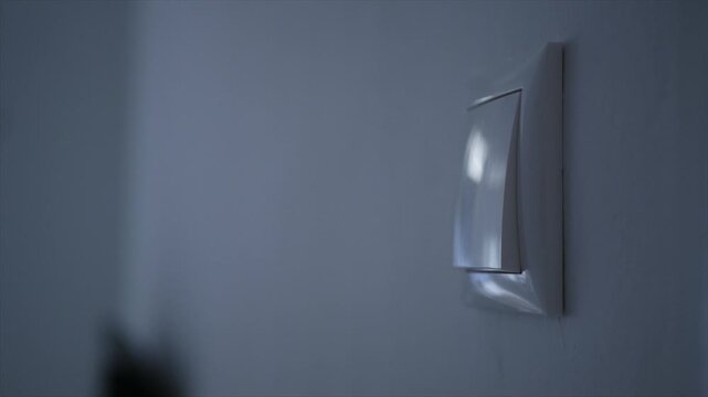 Shutting the Light from the Switch in the Office. A Person Turning off the Light in a Room. Saving Electricity, Economy Concept.