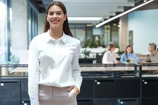 business woman with her staff, people group in background at modern bright office indoors