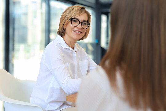 Professional middle aged female psychologist conducting a consultation.
