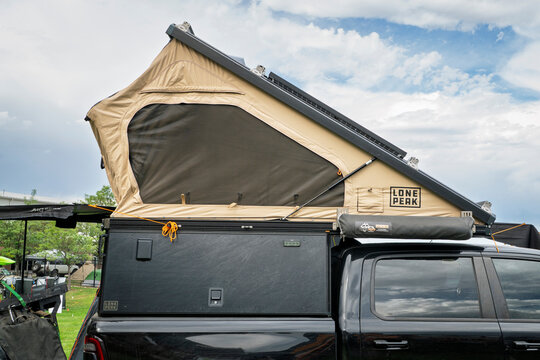 Loveland, CO, USA - August 21, 2026: Long Peak camper with opened tent on a bed of a pickup truck - vehicle setup for overlanding.