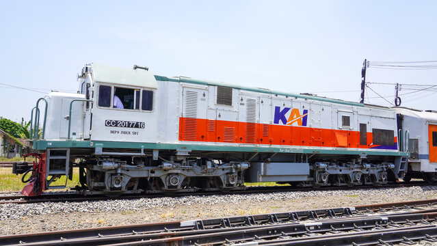 CC 201 77 16 diesel locomotive train of PT KAI stopped at Gundih railway station in Grobogan Central Java Indonesia. Classic public transport engine on railroad track under bright sunny sky.
