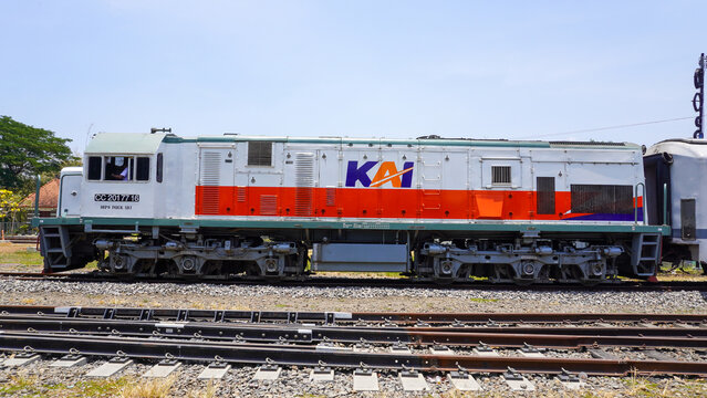 CC 201 77 16 diesel locomotive train of PT KAI stopped at Gundih railway station in Grobogan Central Java Indonesia. Classic public transport engine on railroad track under bright sunny sky.