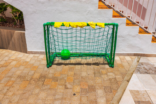 Close-up view of small football goals with ball and training bibs beside hotel staircase.  Gran Canaria. Spain.