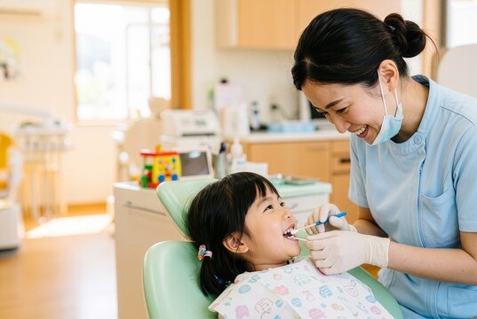 Close up of pediatric dentist applying fluoride to girl's teeth 