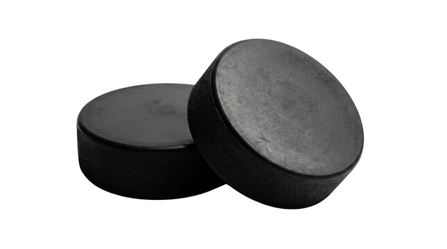 Two black rubber ice hockey pucks positioned close together, featuring one heavily scuffed puck tilted upright and forward showing its textured diamond-patterned circumference against a white