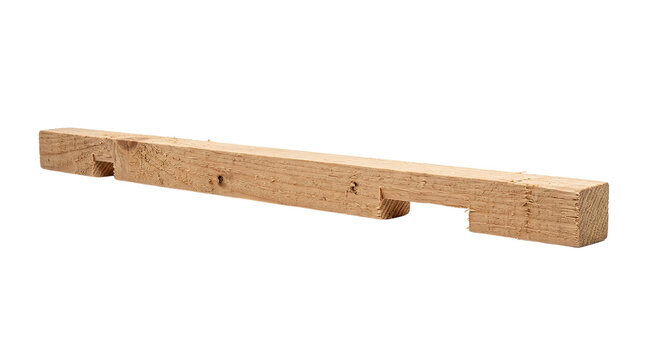 Close-up of raw wooden beam with notches on black background