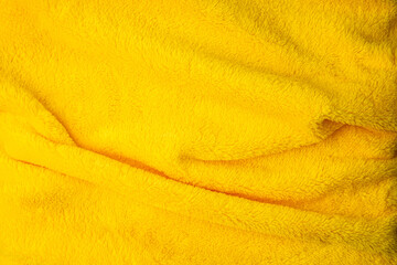Fluffy yellow textile material background close © solidmaks