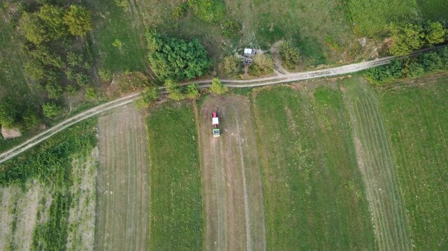 Aerial View of Tractor Working on Green Fields. Agriculture Work. 